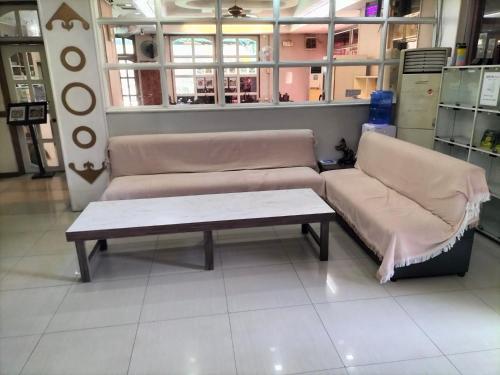 a couch and a coffee table in a store at PJ INN HOTEL in Angeles