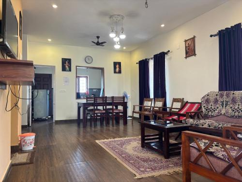 a living room with a couch and a table at Casa Felicia-Adding happy moments to your diary in Ooty