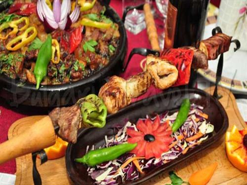 a table with two pans of food on a table at Family Hotel Emaly 2 in Sapareva Banya