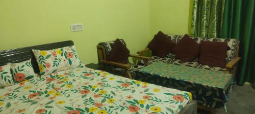 a room with a bed and a couch with pillows at Ayodhya home stay in Faizābād