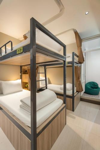 a group of bunk beds in a room at The Oversleep Catba Hostel & Pool Bar in Cat Ba