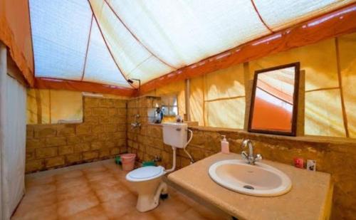 a bathroom with a sink and a toilet at Sam dunes Safari Camp Jaisalmer in Sām