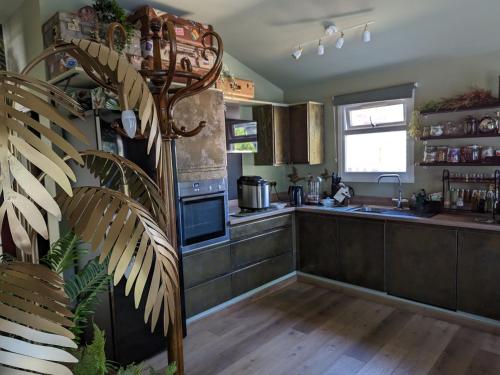 a kitchen with a sink and a stove top oven at Tulana Taggs - floating home on idyllic island in Hampton Hill