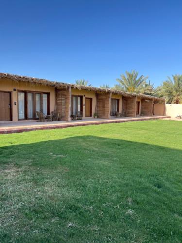 a building with a grass yard in front of it at سيال 1 in AlUla