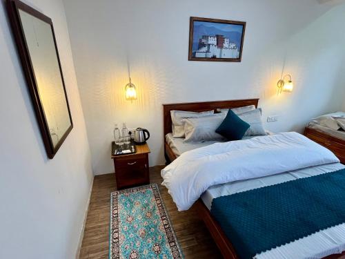 a bedroom with two beds and a mirror at The Breeze Villa Complimentary Nature Walk with Kanchenjunga view in Darjeeling