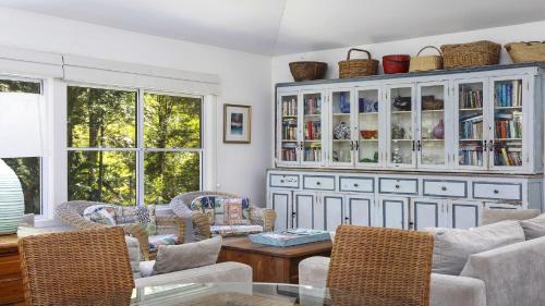 a living room with chairs and a table at Your Beach House in Pearl Beach