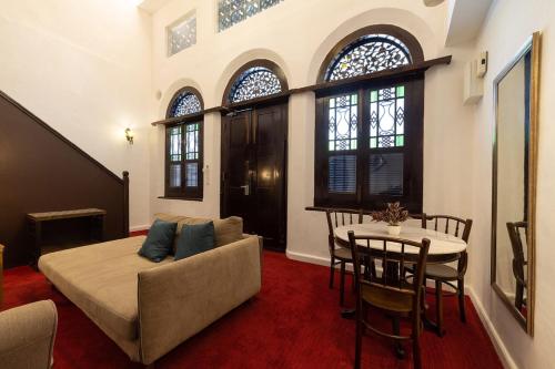 a living room with a bed and a table at Hotel Puri Melaka in Malacca