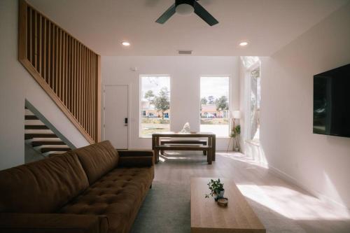 a living room with a couch and a table at Marsh View - Modern Getaway - Mins from Downtown in Saint Augustine