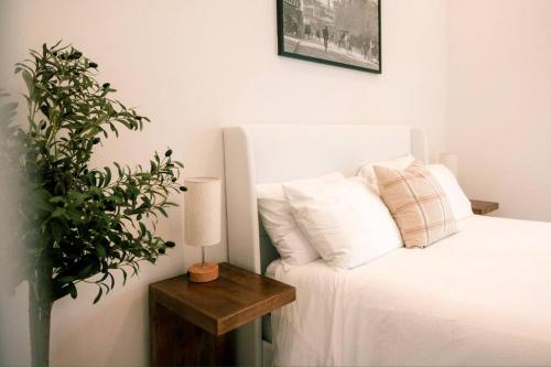 a bedroom with a bed and a table with a plant at Marsh View - Modern Getaway - Mins from Downtown in Saint Augustine