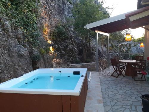 a hot tub in the middle of a patio at Paraskevi's Luxury Studios in Parga