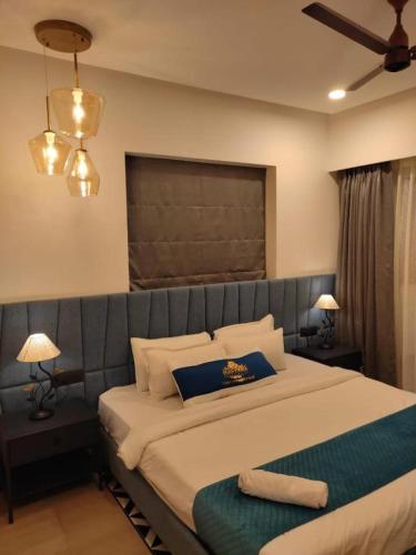 1 dormitorio con cama grande y almohada azul en Kudrat Paradise - Full Villa By AP Villas en Indore