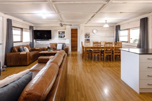a living room with a couch and a table at Palmers Lane Estate Hunter Valley in Pokolbin