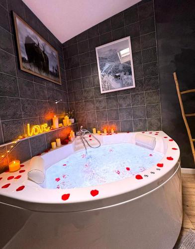 La salle de bains est pourvue d'une baignoire avec le cœur. dans l'établissement Le chalet romantique, SPA, Écran cinéma, Lit king size, day use, 10 min centre, à Amiens