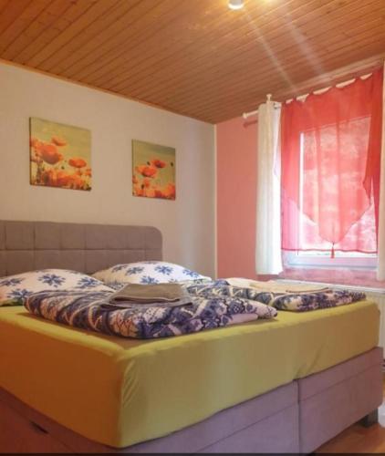 a large bed in a room with a window at Stadtrand Hotel in Hagen