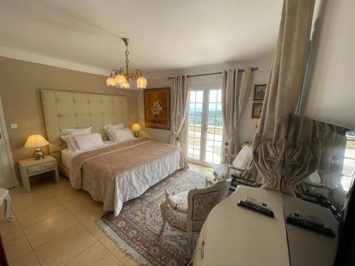 a bedroom with a bed and a table with a desk at La Bergerie B&B in Vence