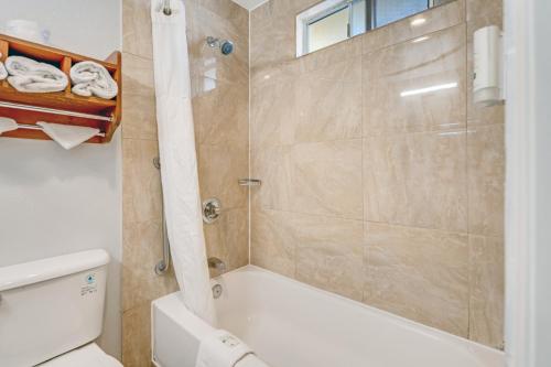 a bathroom with a shower and a toilet at Quality Inn Santa Cruz Downtown Area in Santa Cruz