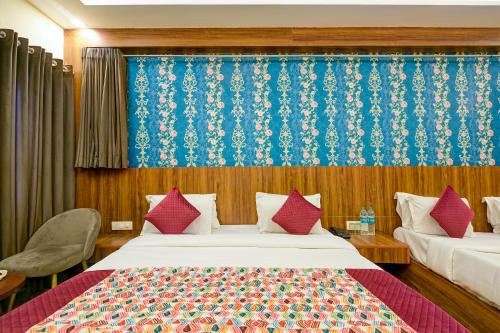 a bedroom with two beds and a blue curtain at Rosewood Suites Near IGI Airport in New Delhi