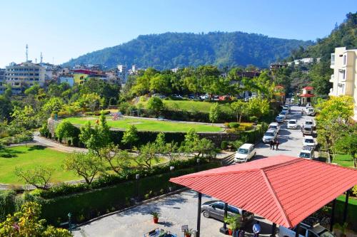 an aerial view of a parking lot with cars parked at Luxury Aloha Majestic Apartments in Rishīkesh