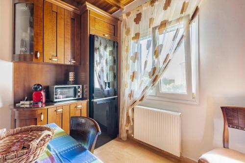a small kitchen with a table and a microwave at Villa Edem in Kassiopi
