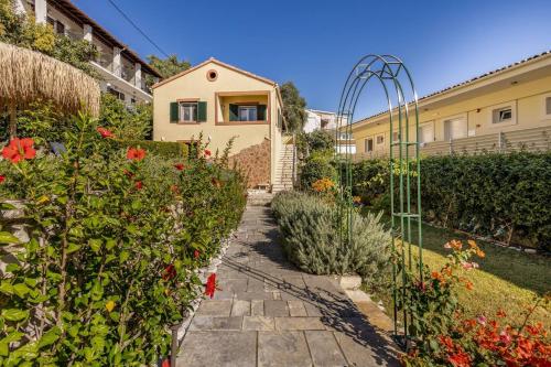 a garden with a gate and some flowers at Villa Edem in Kassiopi