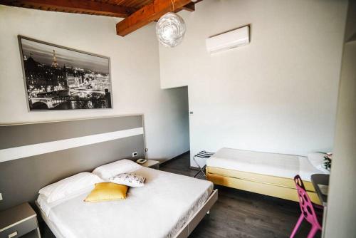 a small room with two beds and a table at Stampa 1968 Hotel e Ristorante in Lavena Ponte Tresa
