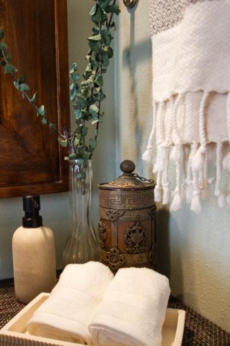 a bathroom with a vase and towels on a table at The Lehua at Keauhou Bay in Kailua-Kona