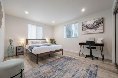 a bedroom with a bed and a desk at Modern NOHO Gem! in Los Angeles