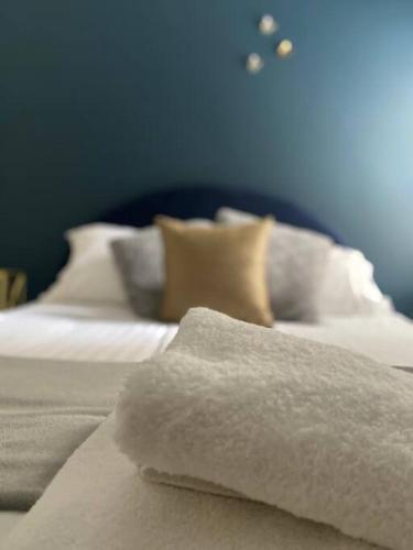 a bed with white sheets and pillows on it at Blue Dreams in Sydney