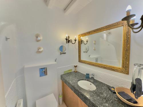 Grace Villa Mykonos في مدينة ميكونوس: حمام مع حوض ومرآة