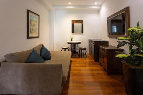a living room with a couch and a table at Hotel Puri Melaka in Malacca