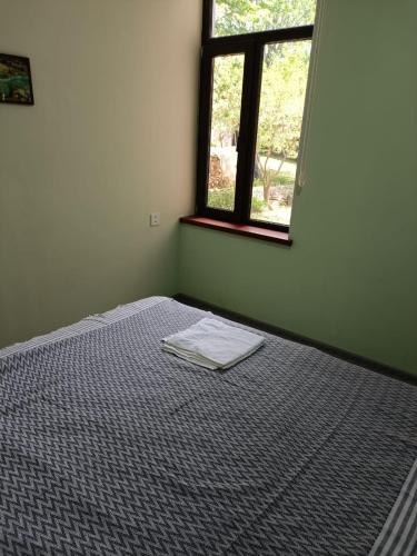 an empty room with a bed and a window at Istisu Valley Spa in İsmayıllı