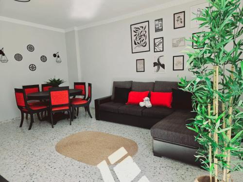 a living room with a black couch and a table at Flat Triana in Las Palmas de Gran Canaria