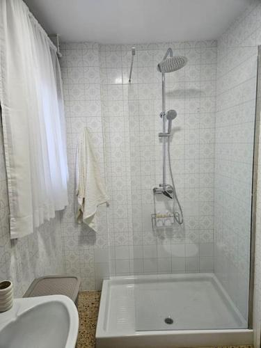 a bathroom with a shower and a tub and a sink at Un balcón sobre el mar in Villanueva de Arosa