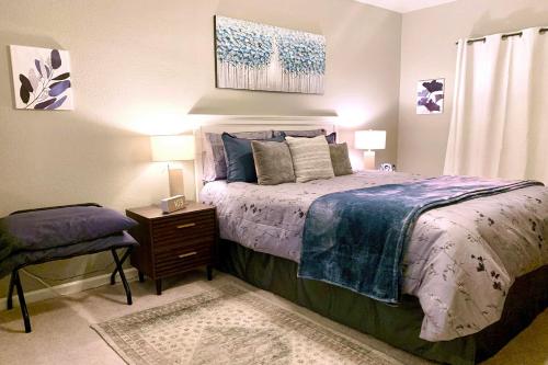 a bedroom with a bed and a table with a chair at Gated Mountain View Resort Community, Centrally Located, Three Heated Pool-Spa Complexes, Half-Mile To Hiking! in Phoenix