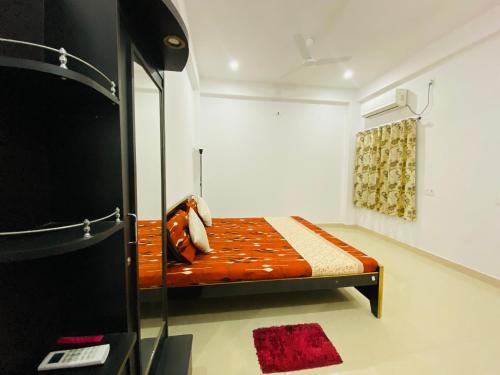 a small bedroom with a bed in a room at Green View Apartments F1 in Varanasi