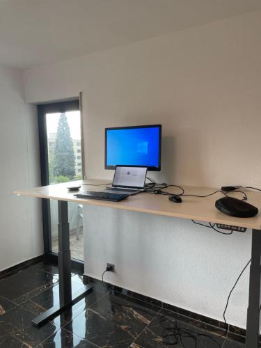 a desk with a laptop computer on top of it at Ferienwohnung Wilusa 2 - Self Checkin in Rheinfelden
