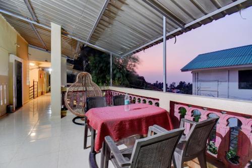 a patio with a table and chairs on a balcony at Hotel Silver Inn in Mahabaleshwar