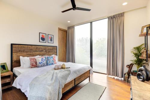 a bedroom with a bed and a large window at The Hanging Villa - A Luxury Pool Villa in Jaipur in Jaipur