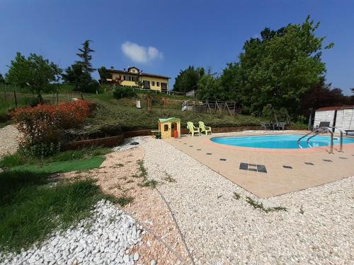 a swimming pool in a yard with a house at I Boidi in Nizza Monferrato