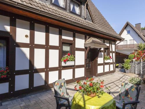 a table and chairs in front of a building at Cosy apartment in Hallenberg near centre in Hallenberg