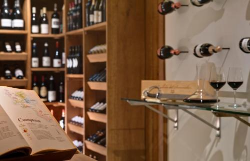 a wine tasting room with a book and wine glasses at Il Lauro Luxury Villa in Ischia