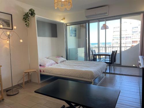 une chambre avec un lit et une table dans une pièce dans l'établissement STUDIO 2-3 pers PARKING CLIM VUE PORT ET MER, à La Grande Motte