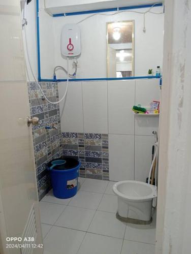a small bathroom with a toilet and a sink at RY Nest in Malaybalay
