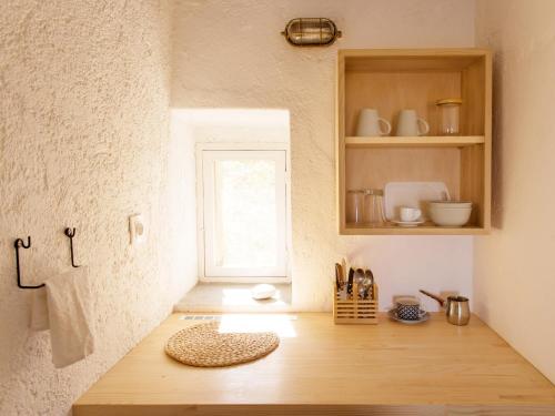 a kitchen with a wooden counter with a window at Alisideri Studios in Karavostasi