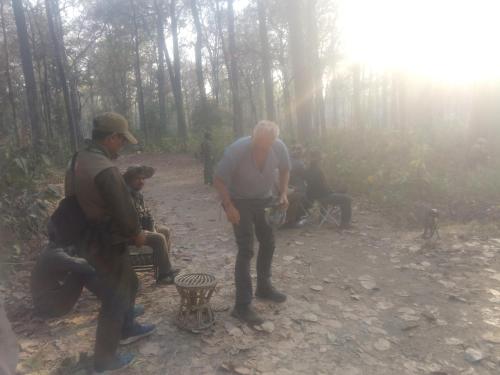 a group of people standing around in the woods at Jungle Base Camp in Bardia