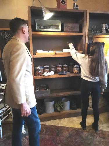 a man and a woman looking into a shelf at Casa Dorita - Free Coffee Corner 8-12 in Cervia