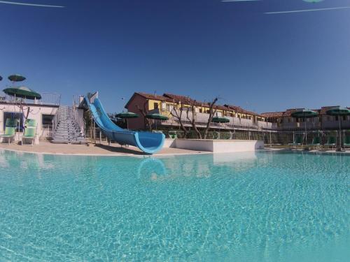 a blue slide in a pool of water at Sunset Village in Marina di Montenero