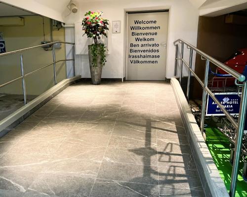 a hallway of a building with a vase of flowers at AMBER HOTEL Bavaria in Bad Reichenhall
