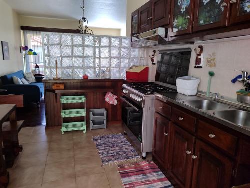 a kitchen with a sink and a stove top oven at casa na Torre in Machico