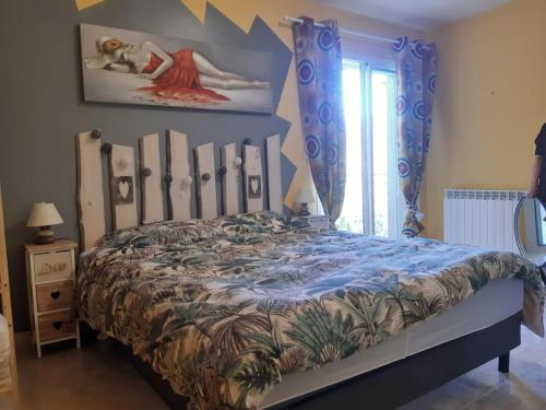 a bedroom with a large bed with a large painting on the wall at Au Murmure des Cascades in La Roque-sur-Cèze